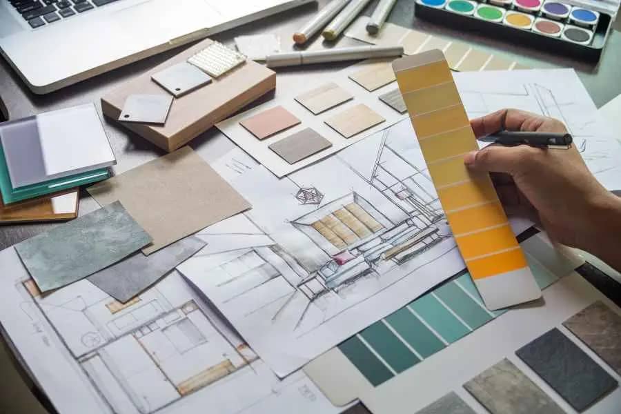 interior architect compares color samples against conceptual sketches